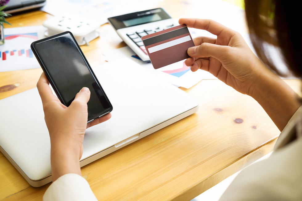 Woman Holding Credit Card and Phone
